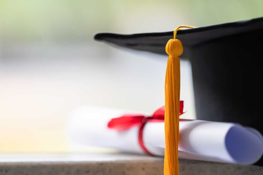 accredited qualifications showing certificate and student hat